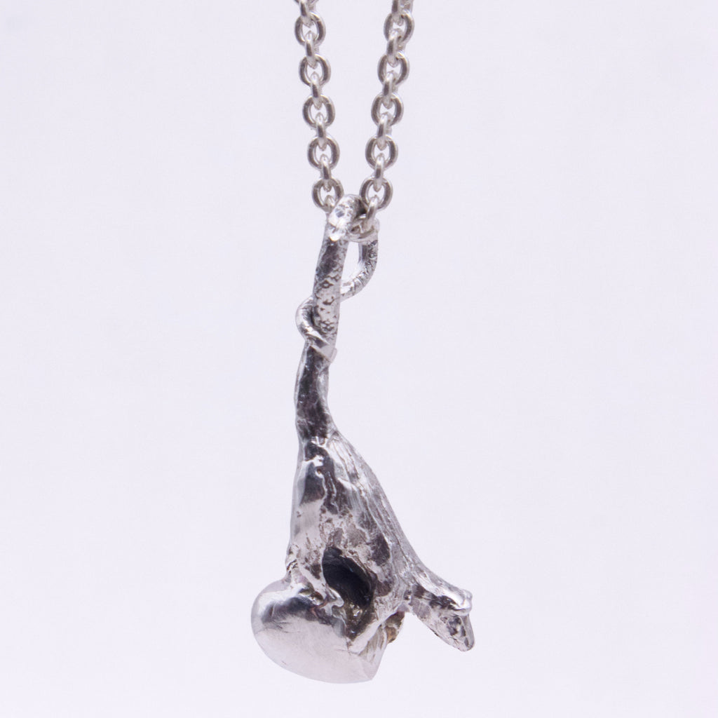 A silver pendant necklace featuring a textured, organic rat-shaped charm hanging from a silver link chain, shown against a plain white background.