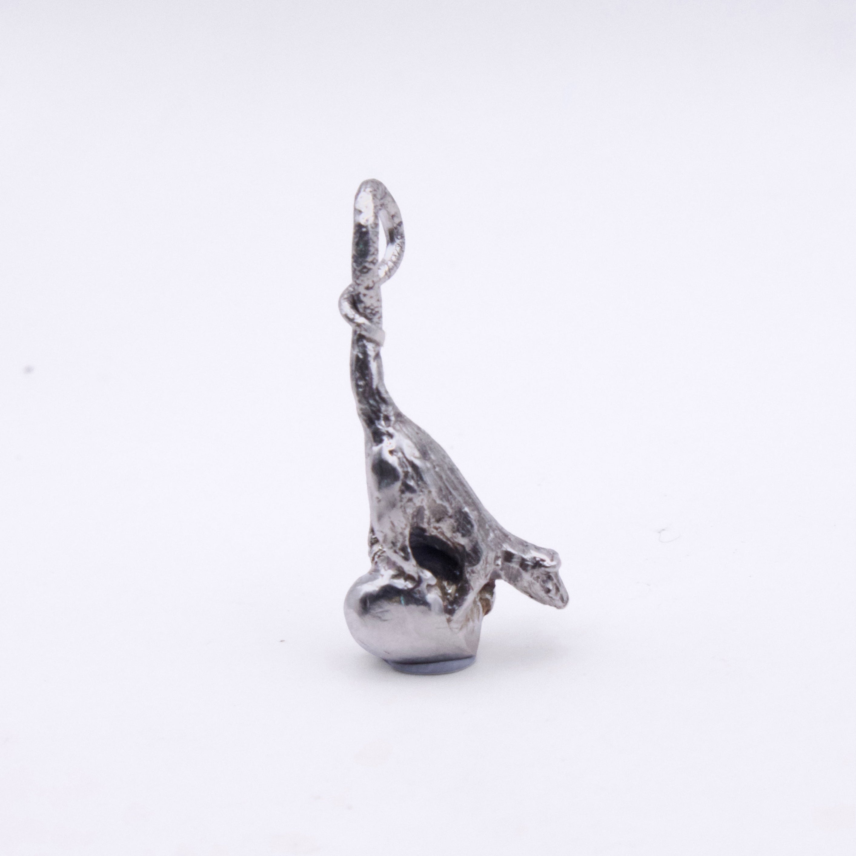 A small silver-toned metal charm shaped like a stylized rat with a loop at the top, photographed on a plain white background.