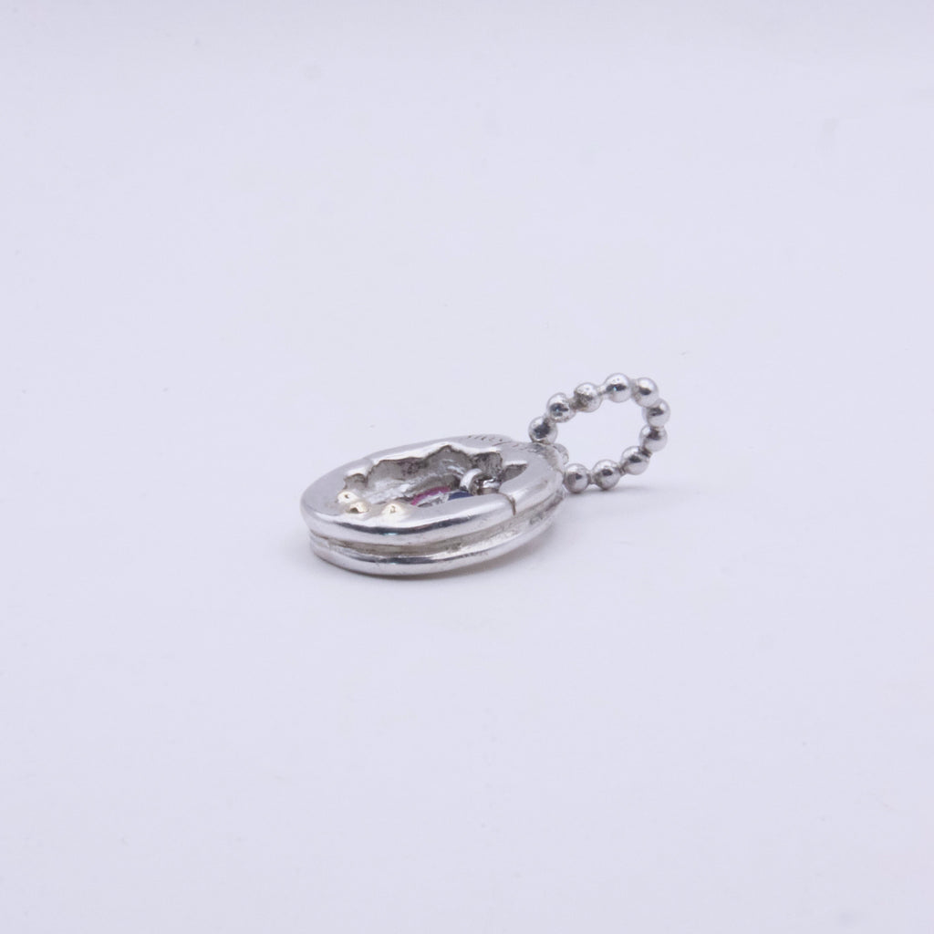 A small silver Y2K charm with a textured, hammered finish and a matching silver ball chain, shown on a plain white background.